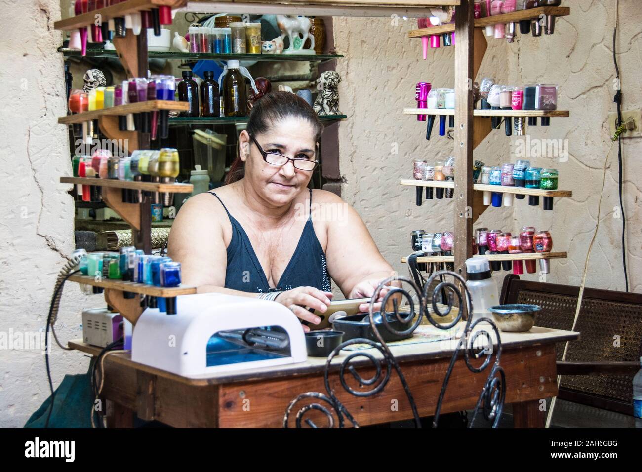 People of Havana Series - A middle aged, Cuban manicurist, at her work station. Stock Photo