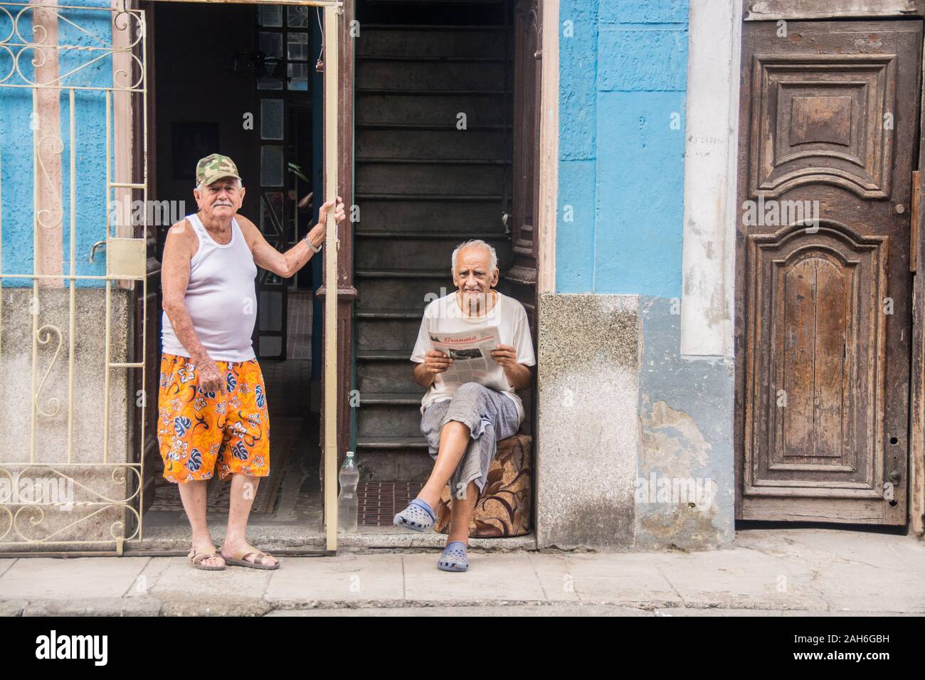 People of Havana Series - Cuban neighbors outside their respective homes, getting together to talk and socialize. Stock Photo