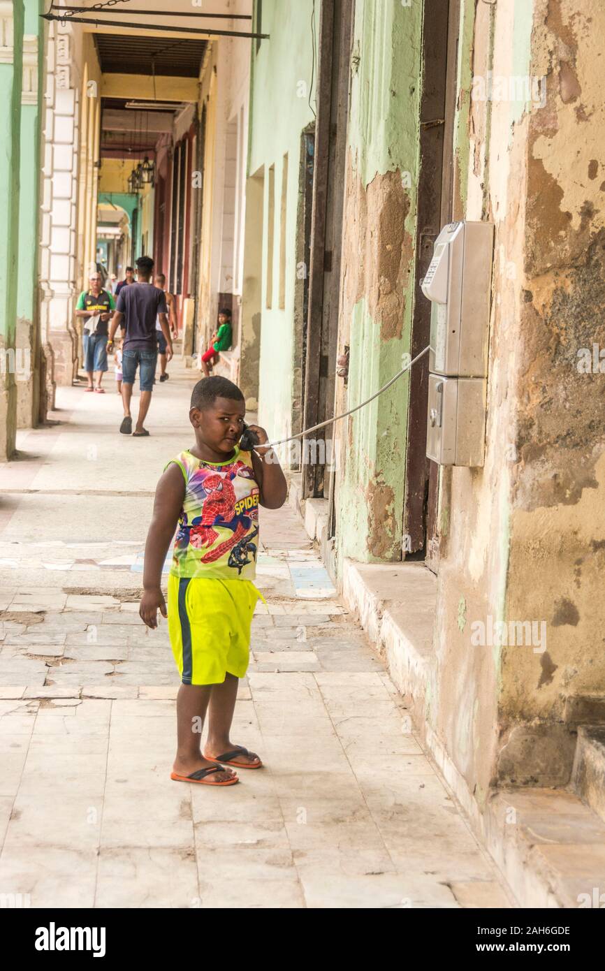 People of Havana Series - A Cuban boy talking on the phone, Havana, Cuba. Stock Photo