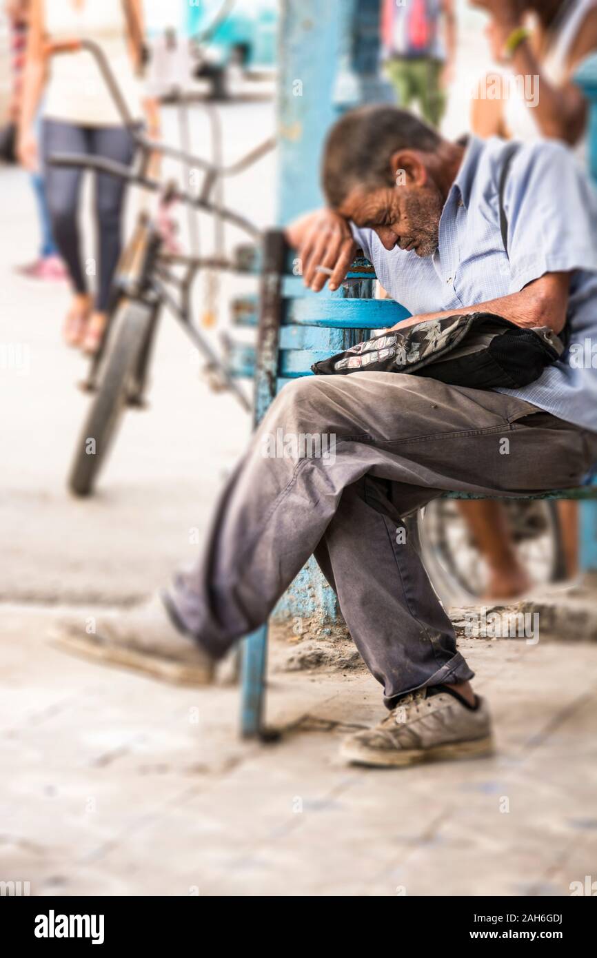 People of Havana Series - A middle aged, working man, waiting at the bus stop, 7:30 a.m. to catch a bus to work. Stock Photo