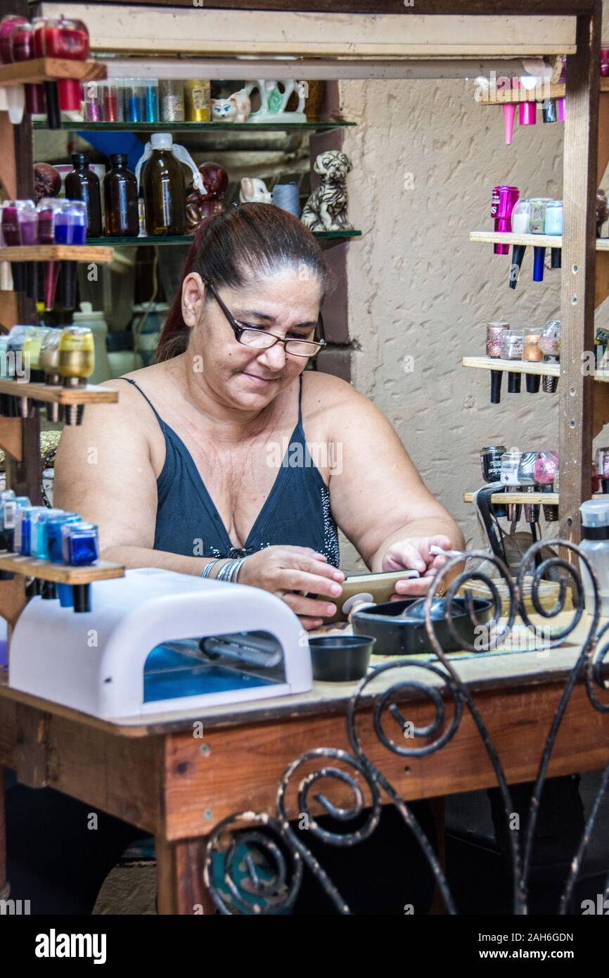 People of Havana Series - A middle-aged, woman, manicurist organizing her station. Stock Photo