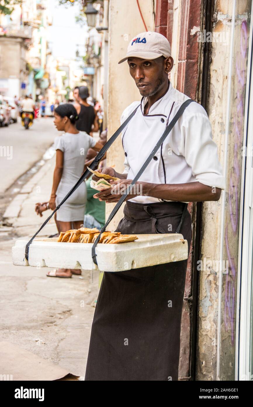 People of Havana Series - A Cuban vender selling pastries on a street corner in Havana. Stock Photo