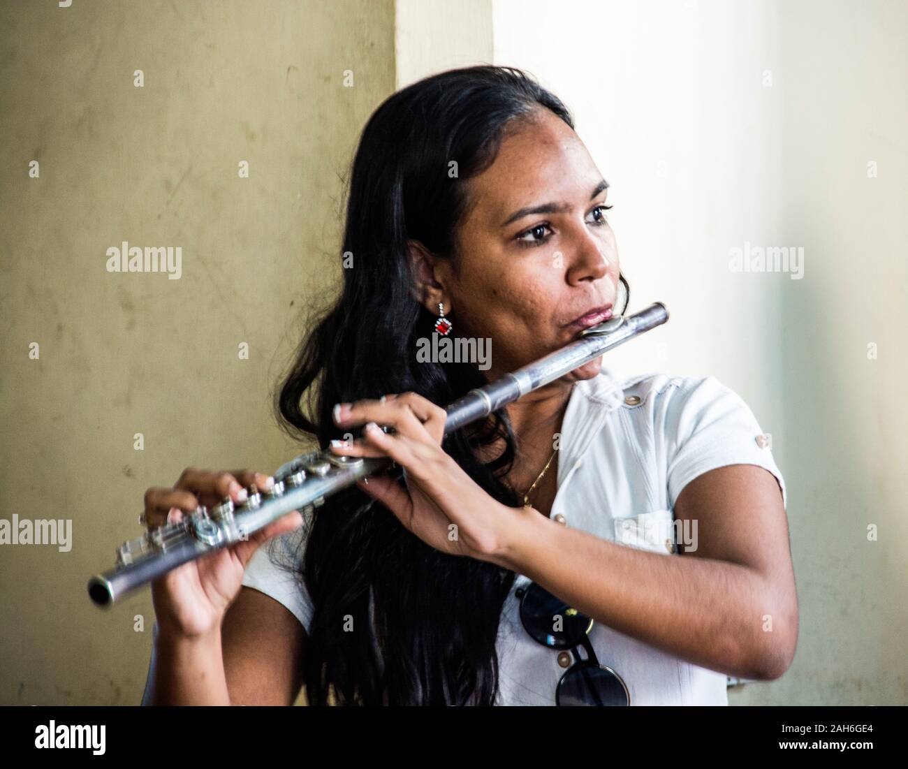 People of Havana Series -  A Cuban woman playing the flute in a Cuban bar. Stock Photo