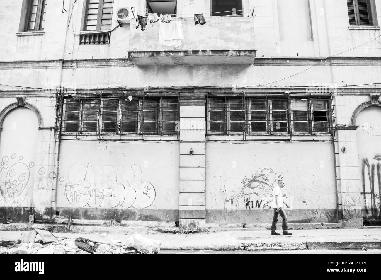 People of Havana Series - A lone, Cuban man, walking down the sidewalk in front of a building. Stock Photo