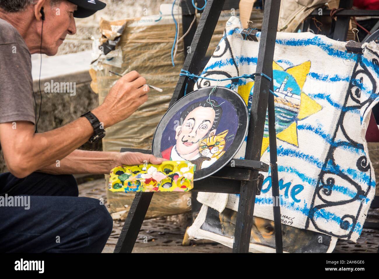 People of Havana Series - A Cuban artist painting a plate. Stock Photo