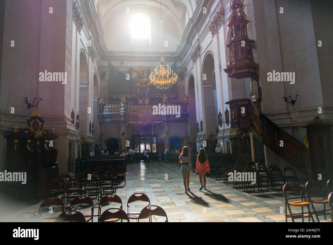 Two young women inside Saints Peter and Paul Church, Kraków, Poland Stock Photo
