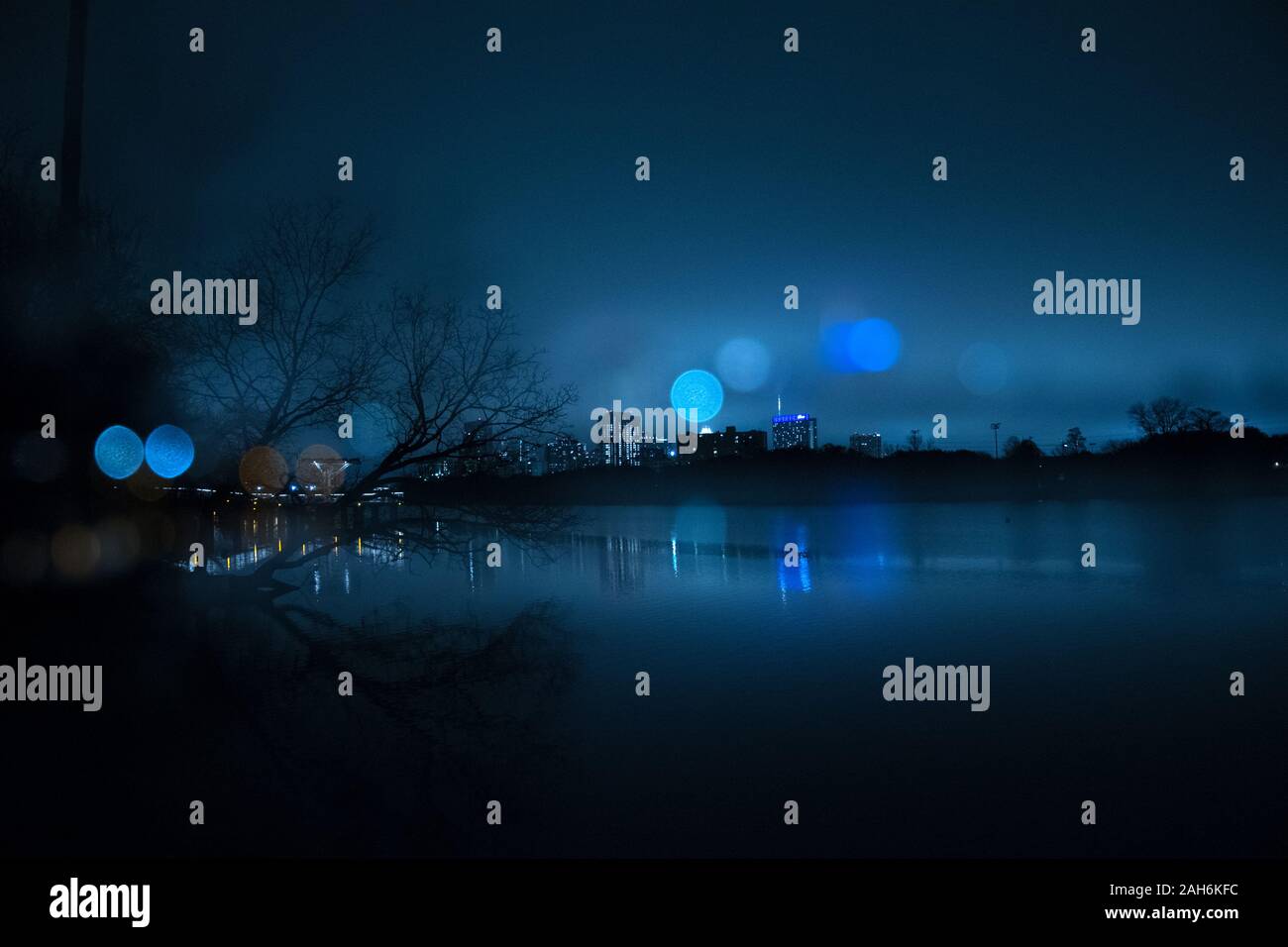 City skyline of Austin, Texas, at night along the Colorado River Stock Photo
