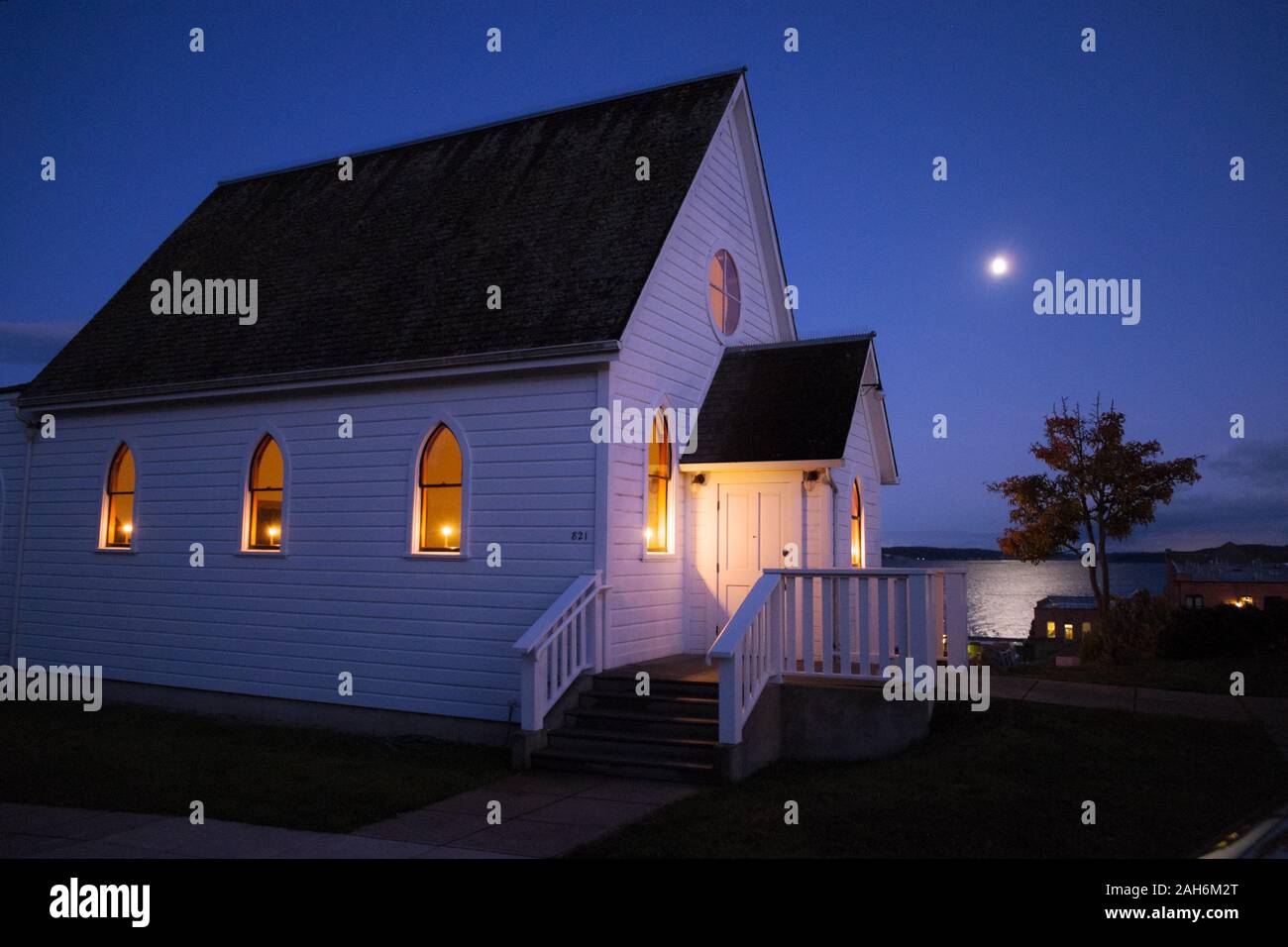 Moonrise over a church in Port Townsend, Washington, USA Stock Photo