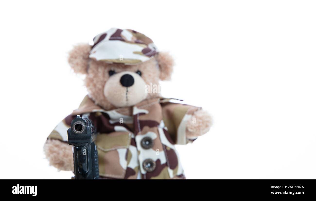 Army, military concept. Cute teddy bear in soldier uniform holding a
