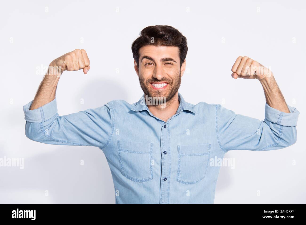 Photo of amazing handsome guy raising arms showing perfect biceps ...