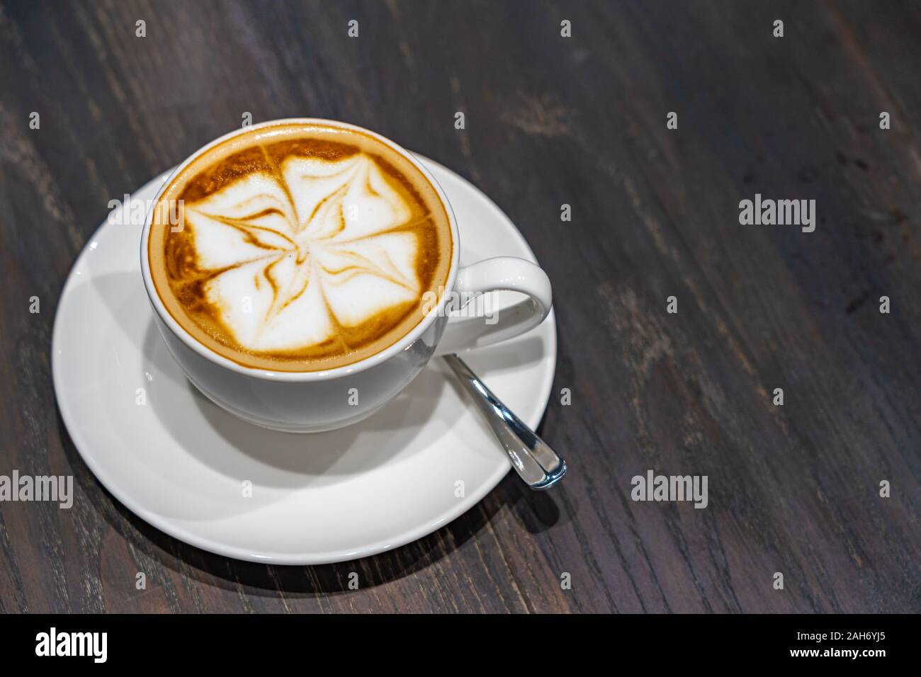 Hot cappuccino with latte art froth milk on wooden background Stock Photo -  Alamy