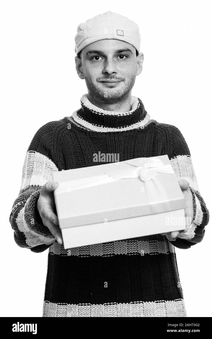 Studio shot of young man giving gift box Stock Photo