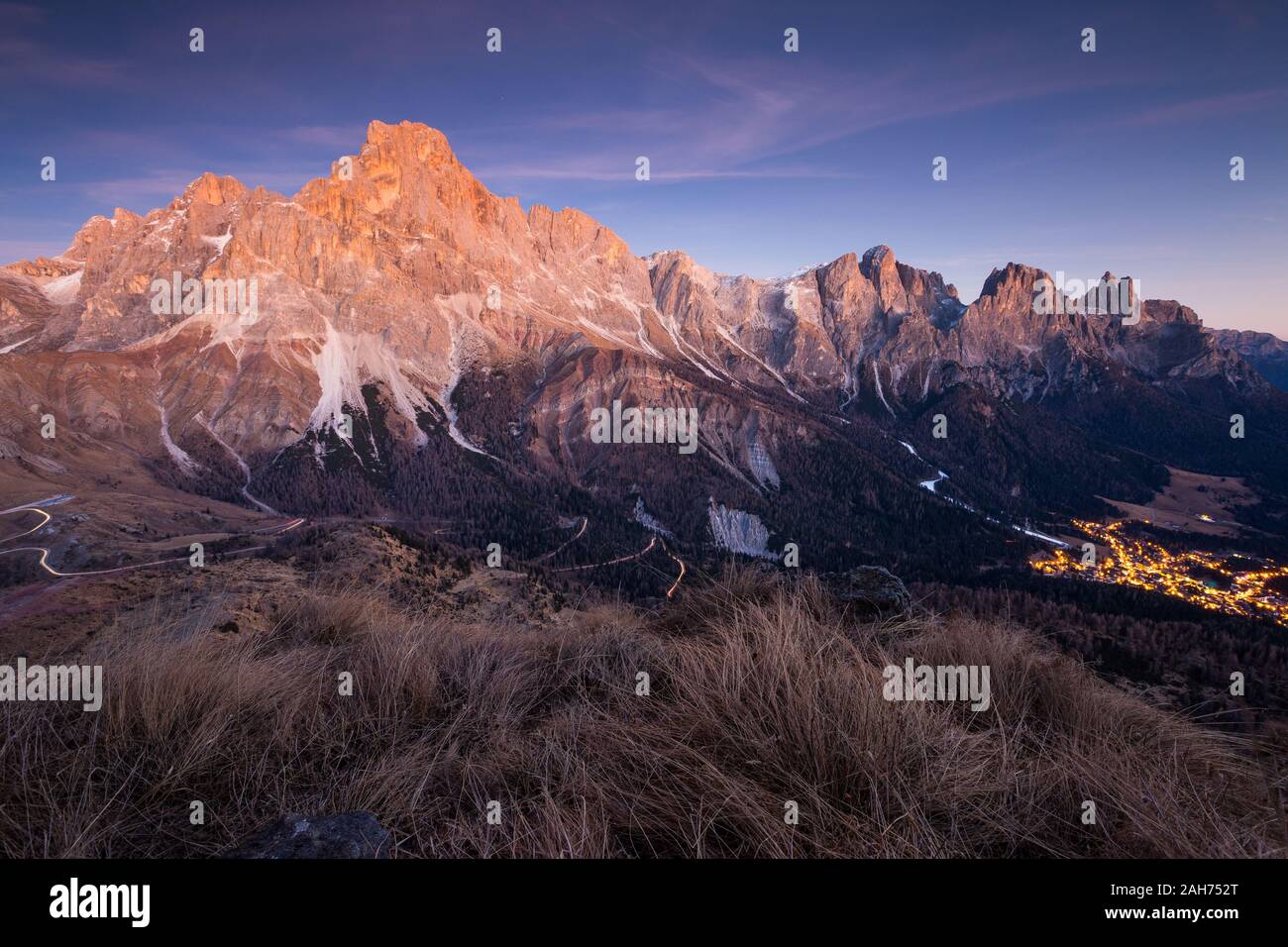 The Pale di San Martino massif at dusk, sunset. Rolle pass and San Martino di Castrozza lights. The Dolomites of Trentino. Italian Alps. Europe. Stock Photo