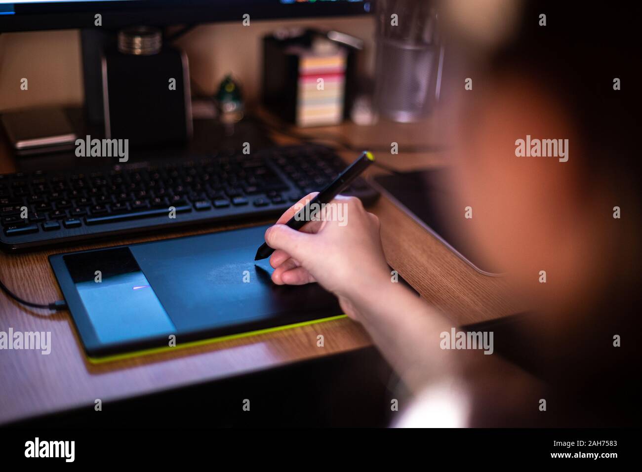 A person using graphic tablet with pen and working on new project idea Stock Photo