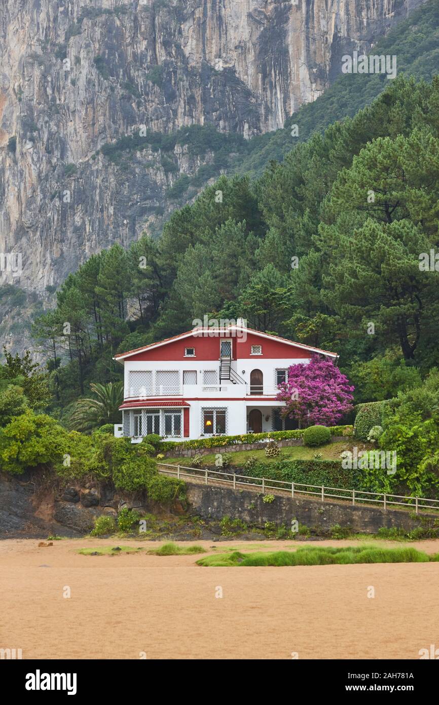 Spanish coastline with beach forest rocky mountain and picturesque house Stock Photo