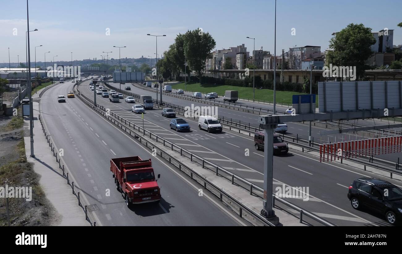 ISTANBUL, TURKEY - JULY 30 2019: Automobiles drive on modern highway running along calm azure sea against clear blue sky on sunny day Stock Photo