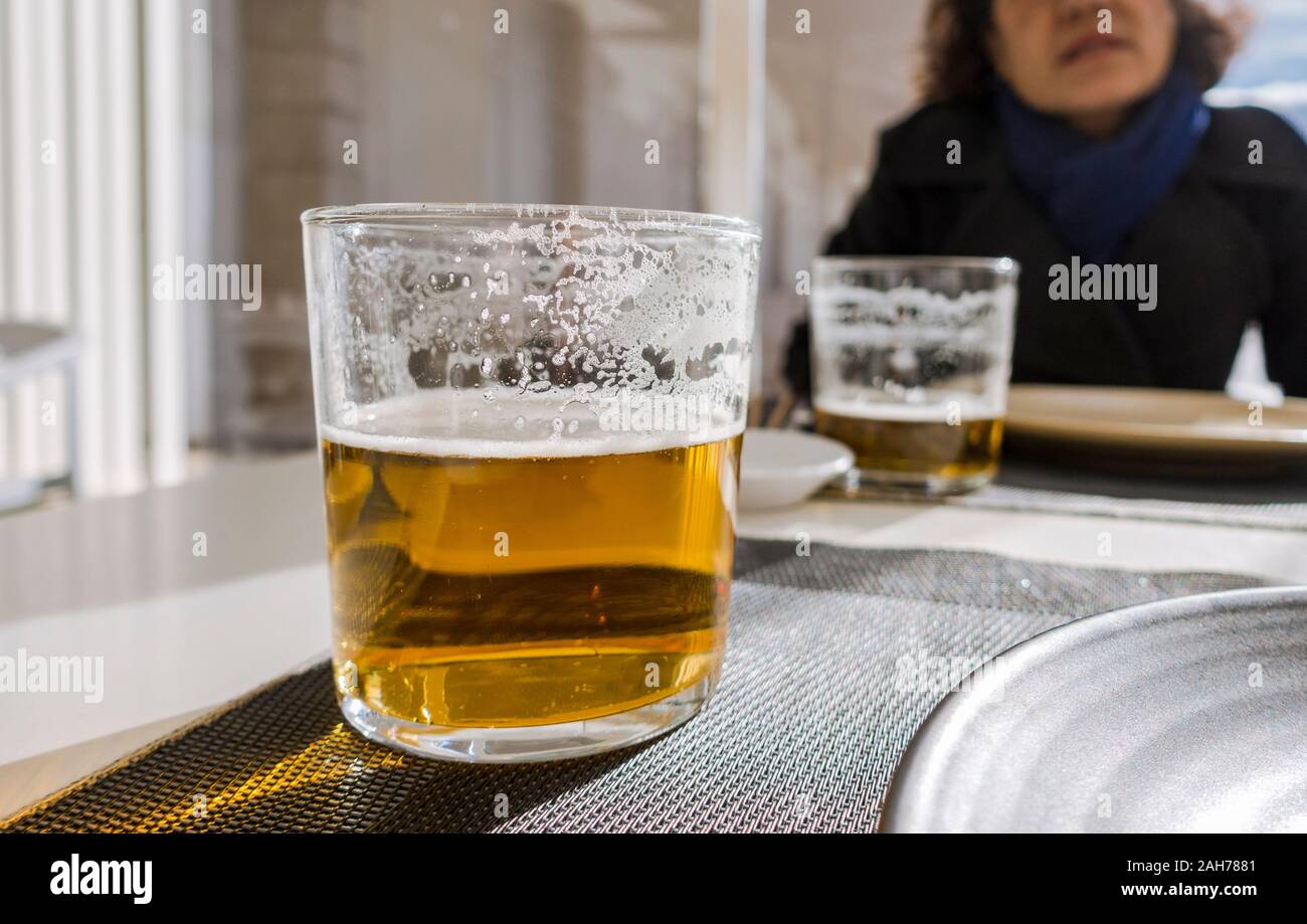 Glass of beer on a table served in restaurant, the spanish way. Stock Photo