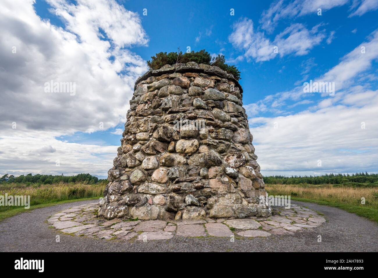 A scottish battle monument consisting in a mount made of stones against a blue sky with clouds Stock Photo