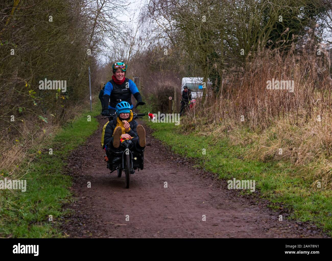 East Lothian, Scotland, United Kingdom, 26 December 2019. Resolution Race 2019: Lee Craigie, Active Nation Commissioner for Scotland, and Jenny Graham, Scottish endurance cyclist plus two other female cyclists lead the challenge for sustainable travel by setting off today on cargo bikes to cycle non-stop in pairs on a 1000km route from Edinburgh to Copenhagen, seen here on the Longniddry to Haddington railway path. Pictured: Jenny Graham cycling with Philippa Battye Stock Photo