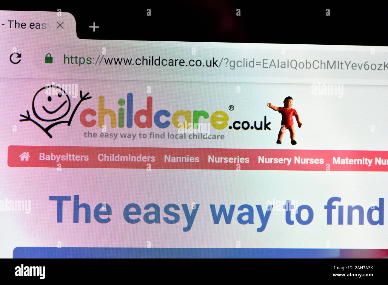 Childcare.co.uk web page with miniature figurine child Stock Photo
