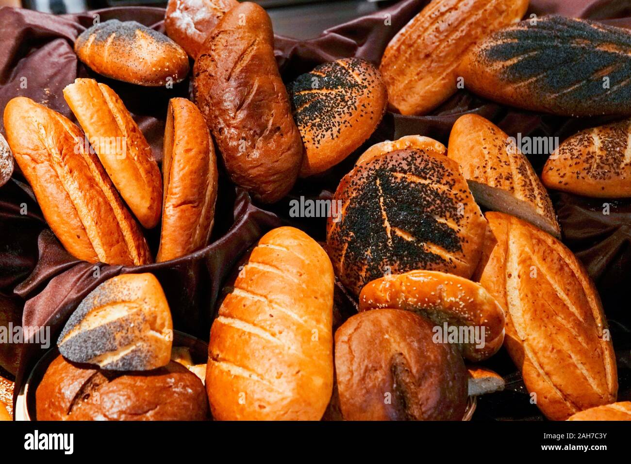 many rolls of different breads in the bakery restaurant Stock Photo