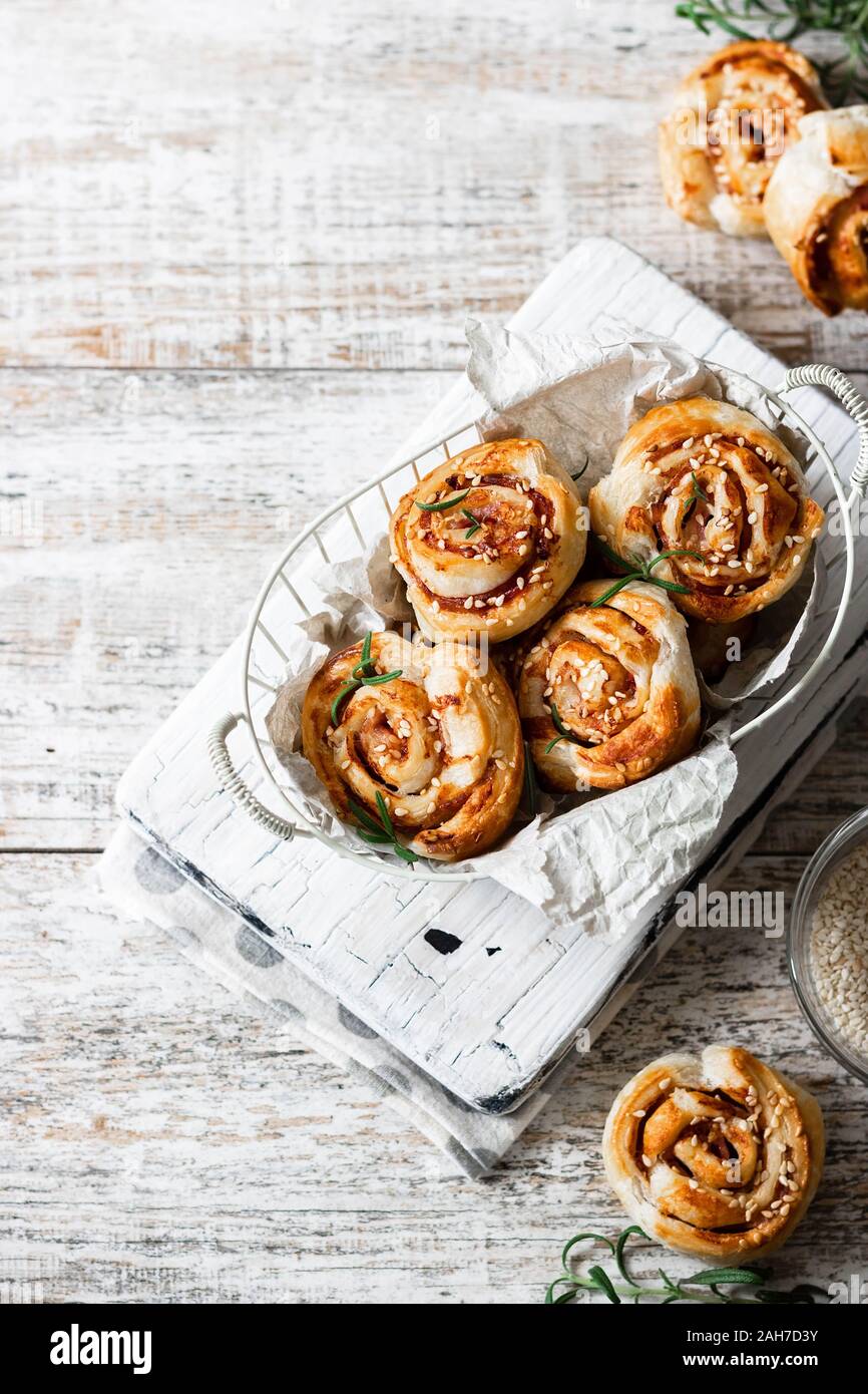 Unsweetened snails and puff pastry with bacon and sesame seeds