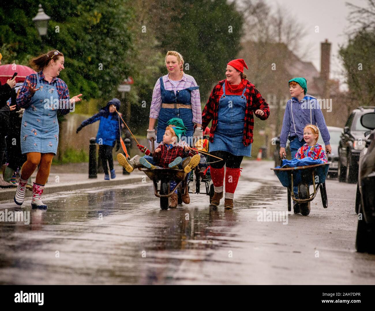 East Hoathly, UK. 26 December, 2019.  Villagers compete in their annual Boxing Day Pram Race through the rainy streets of East Hoathly, East Sussex, UK. The wacky racers build their machines in secret each year before racing their creations to the Kings Head pub. Credit:  Jim Holden/Alamy Live News. Stock Photo