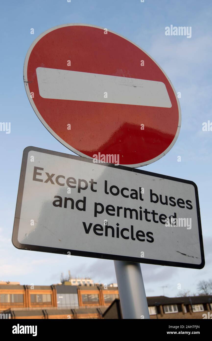 no entry sign with qualifying sign reading except local buses and permitted vehicles, in twickenham, middlesex, england Stock Photo