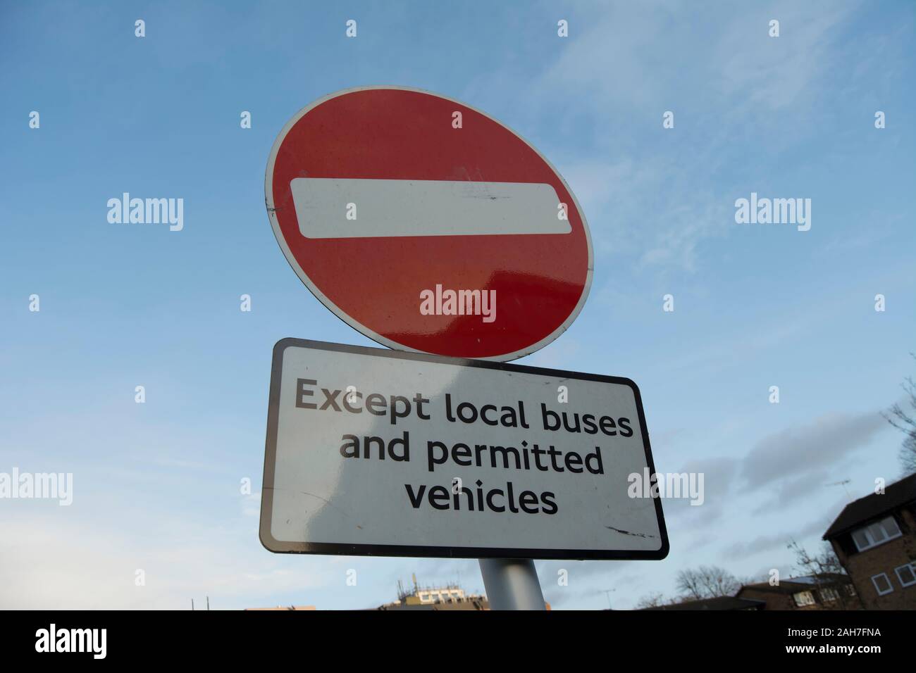 no entry sign with qualifying sign reading except local buses and permitted vehicles, in twickenham, middlesex, england Stock Photo