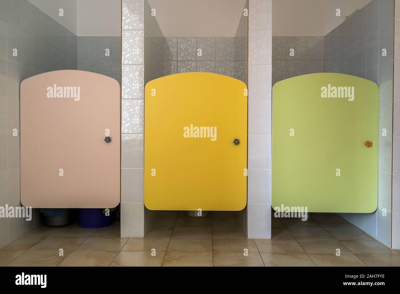 Colorful toilet doors in elementary school bathroom interior Stock Photo Alamy