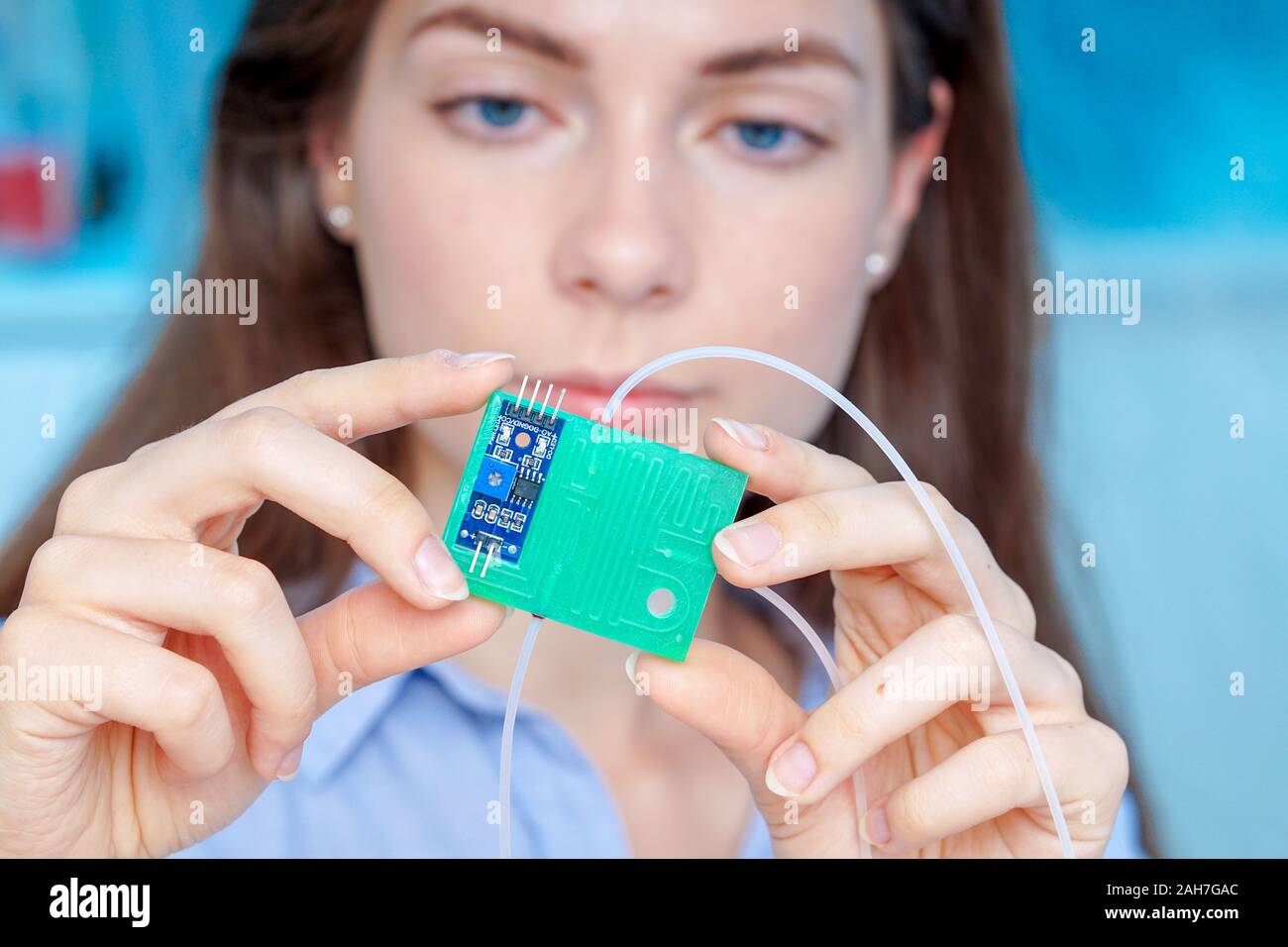 Girl holding polymers BioMEMS biomedical microelectromechanical