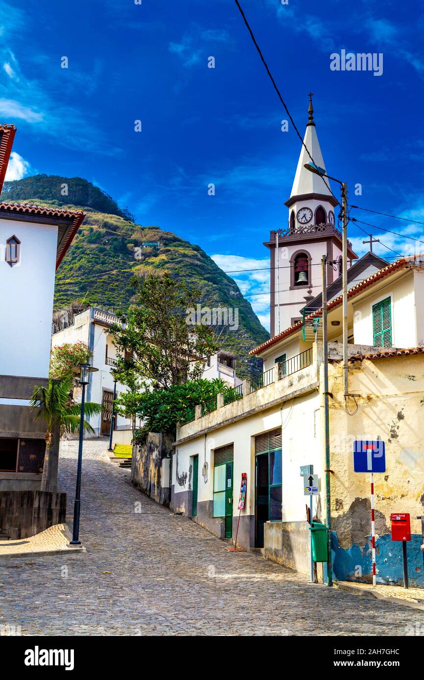 Narrow charming street and church tower in Porto Moniz, Madeira, Portugal Stock Photo