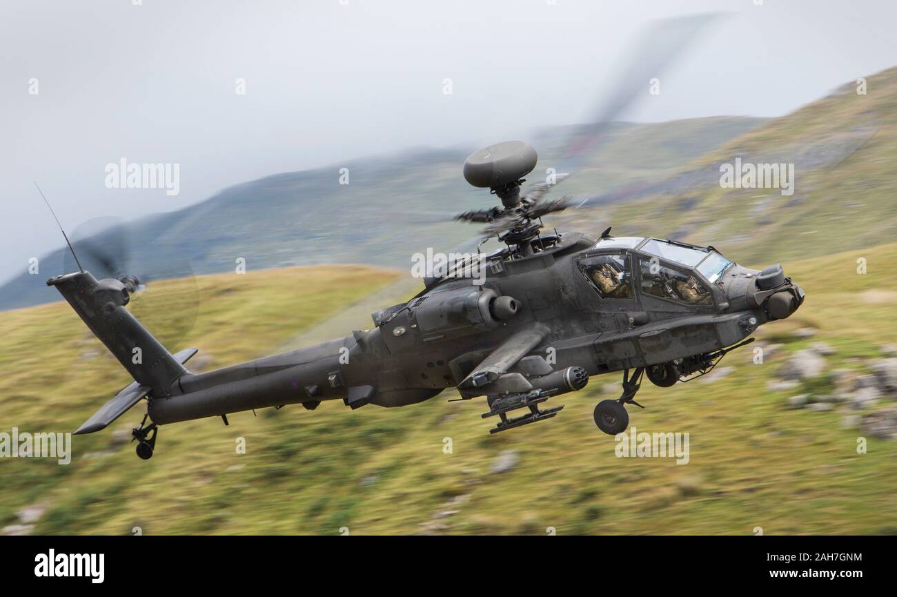 The Boeing AH-64 Apache is an American twin-turboshaft attack helicopter with a tailwheel-type landing gear arrangement and a tandem cockpit for a cre Stock Photo