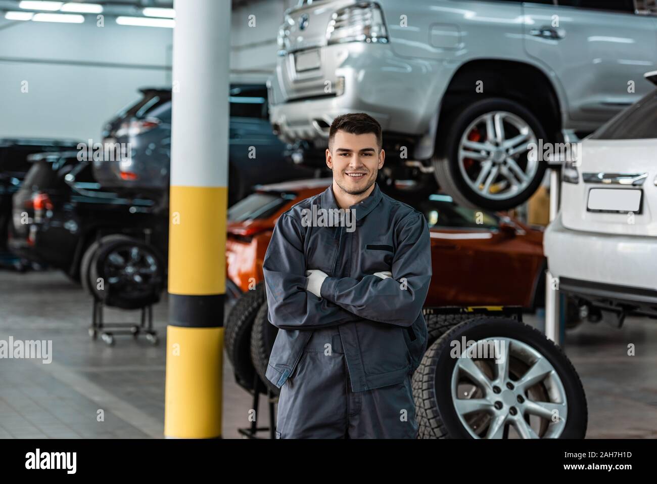 Positive handsome young auto mechanic hi-res stock photography and ...