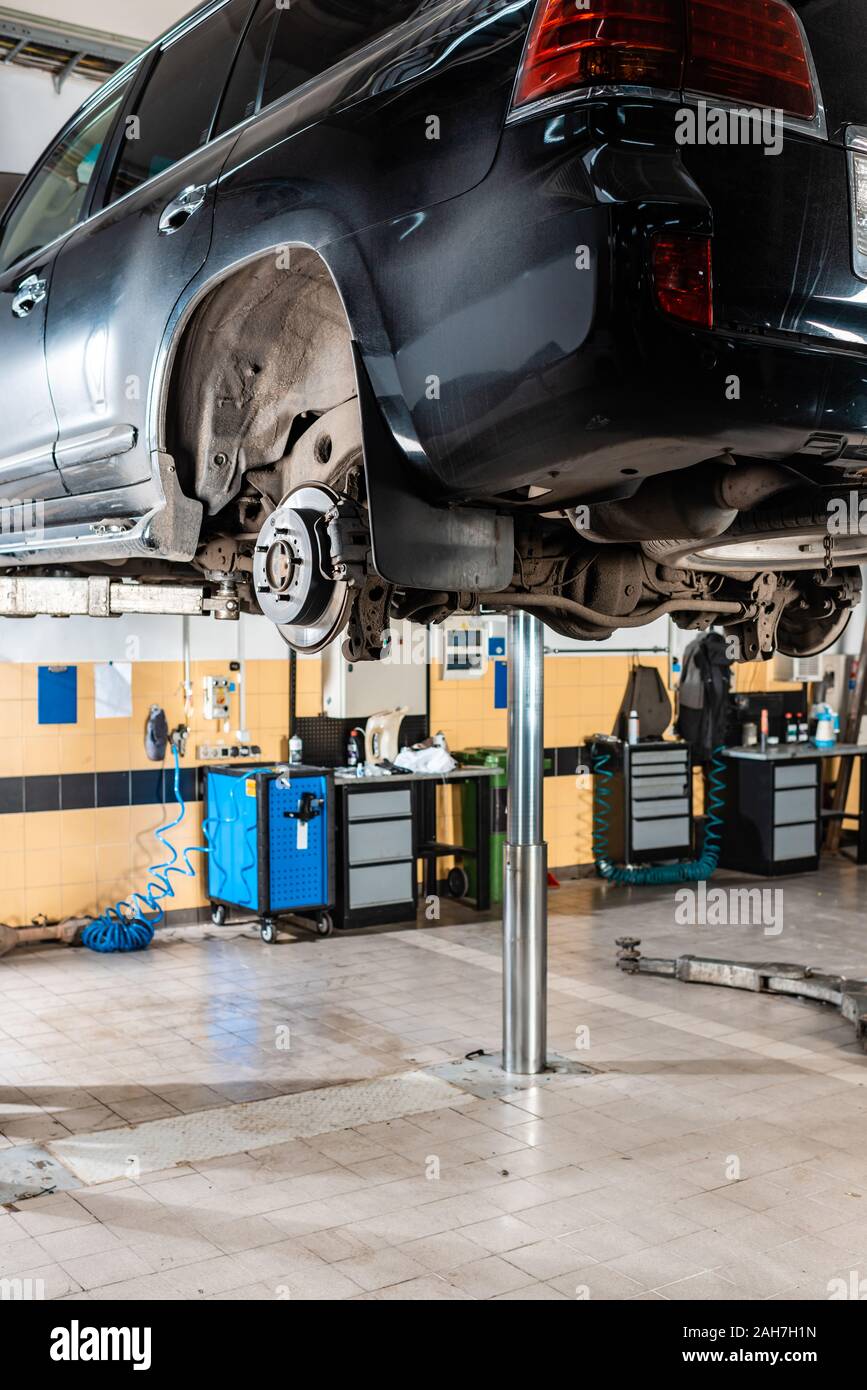 modern car raised on car lift for diagnostics in workshop Stock Photo ...