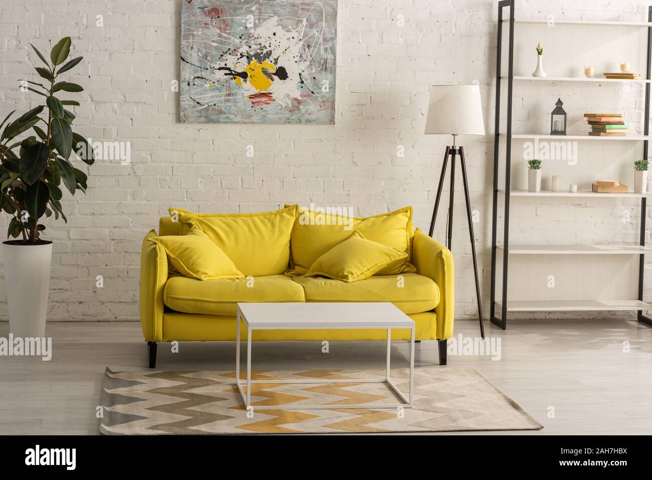 Interior with yellow sofa in living room Stock Photo - Alamy
