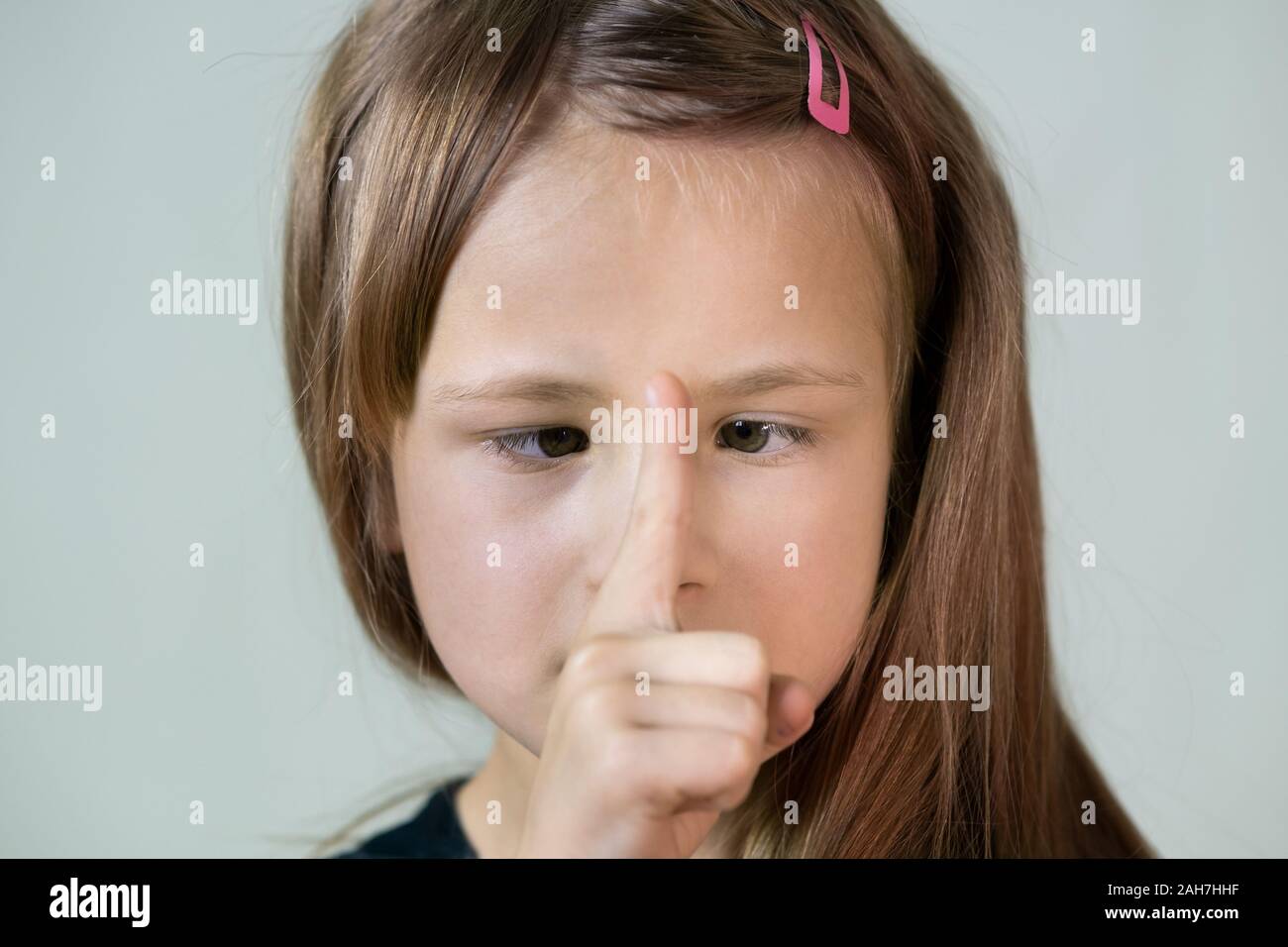 Close-up portrait of happy smiling little girl with long hair looking ...