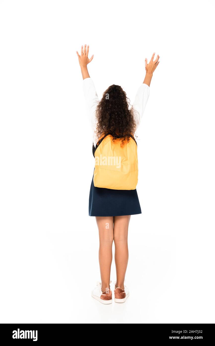 back view of african american schoolgirl gesturing with raised hands on ...