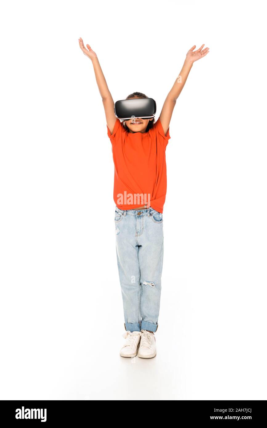 full length view of smiling african american child standing with raised