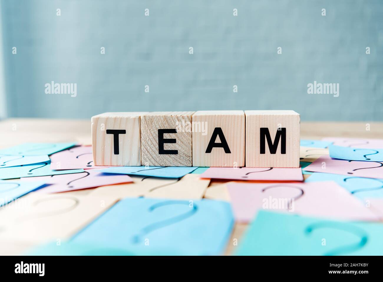 selective focus of team lettering on cubes near sticky notes with ...