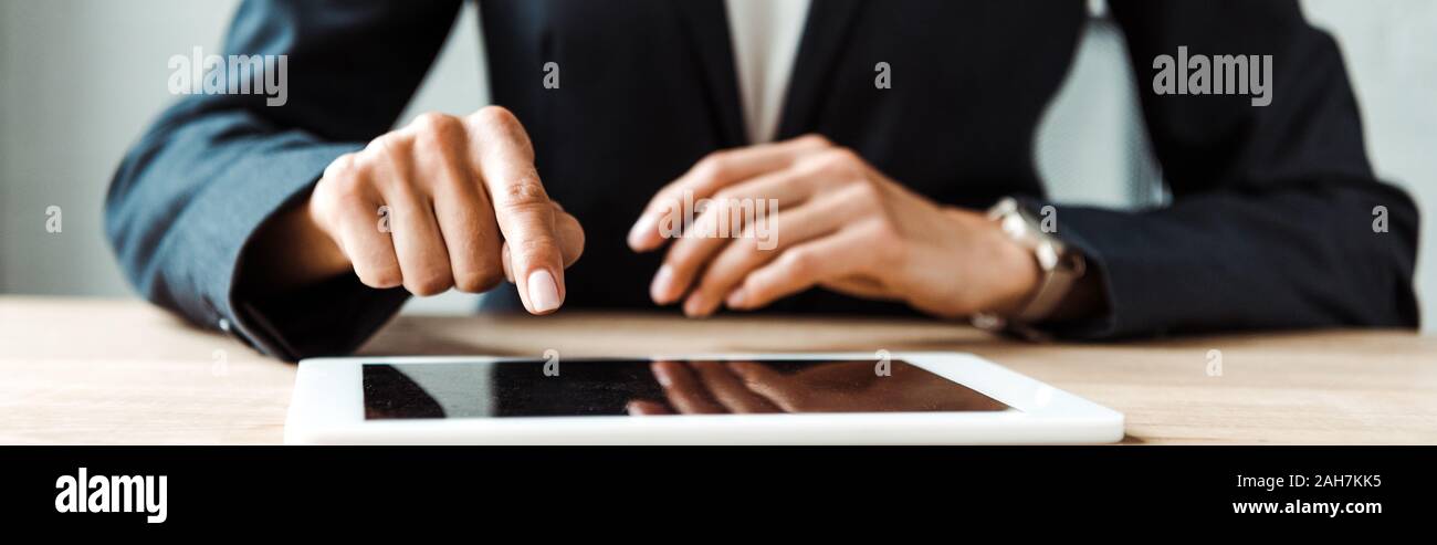 panoramic shot of woman pointing with finger at digitla tablet with blank screen Stock Photo