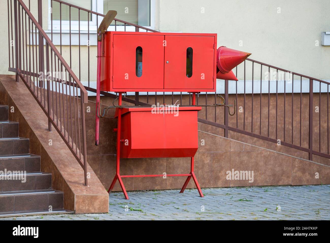 Red fire protection utencils outsine a building Stock Photo - Alamy