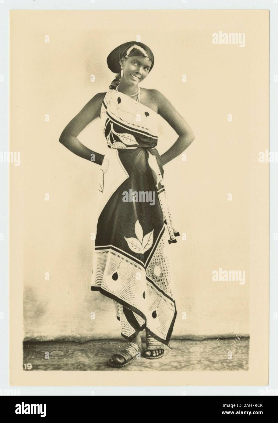 Somalia, Portrait of a smiling Somali girl, wearing a brightly coloured  wrap dress, circa 1940. 2000/084/1/1/6/5/271 Stock Photo - Alamy