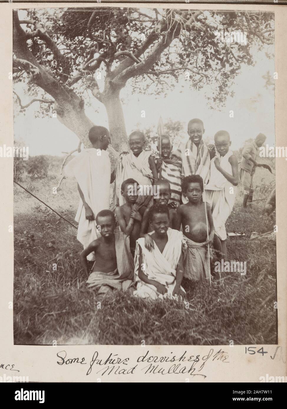 SomaliaJubaland, A group of Somali children pose under a treeOriginal manuscript caption: Some future dervishes of the Mad Mullah, circa 1910. 2005/078/1/154. Stock Photo