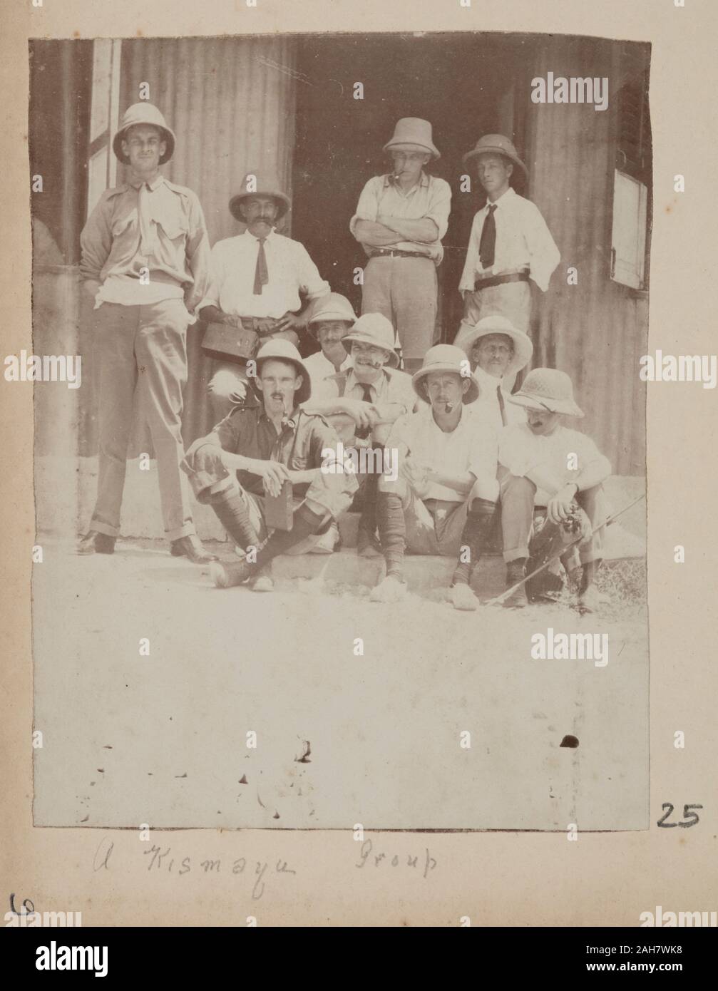 SomaliaJubaland, Eleven men in pith helmets posed for a group photographOriginal manuscript caption: Kismayu Group, circa 1910. 2005/078/1/25. Stock Photo