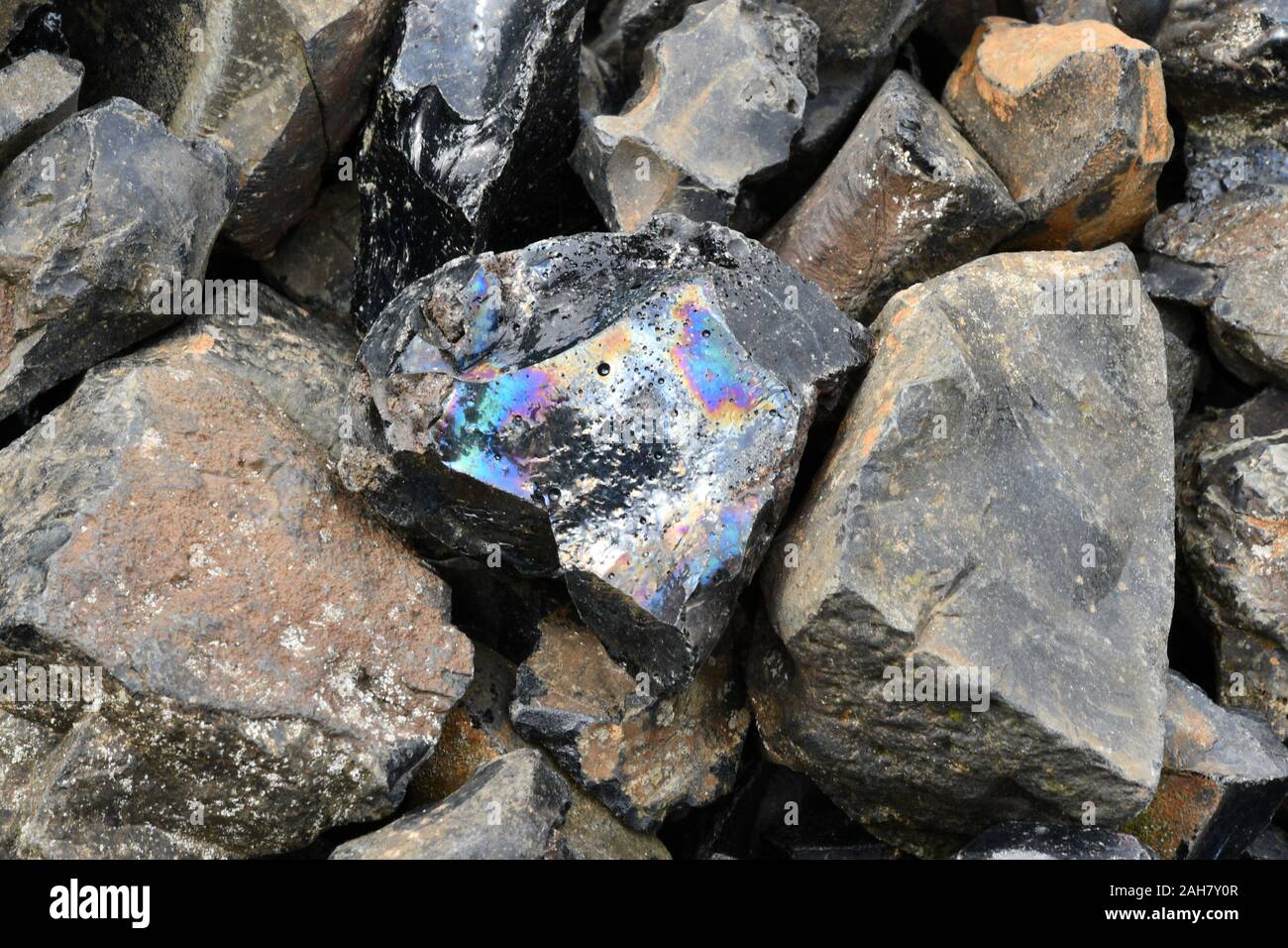 Rainbow coloured slag from the old Roman and Victorian lead mine workings near Charterhouse on the Mendip Hills in Somerset. Stock Photo