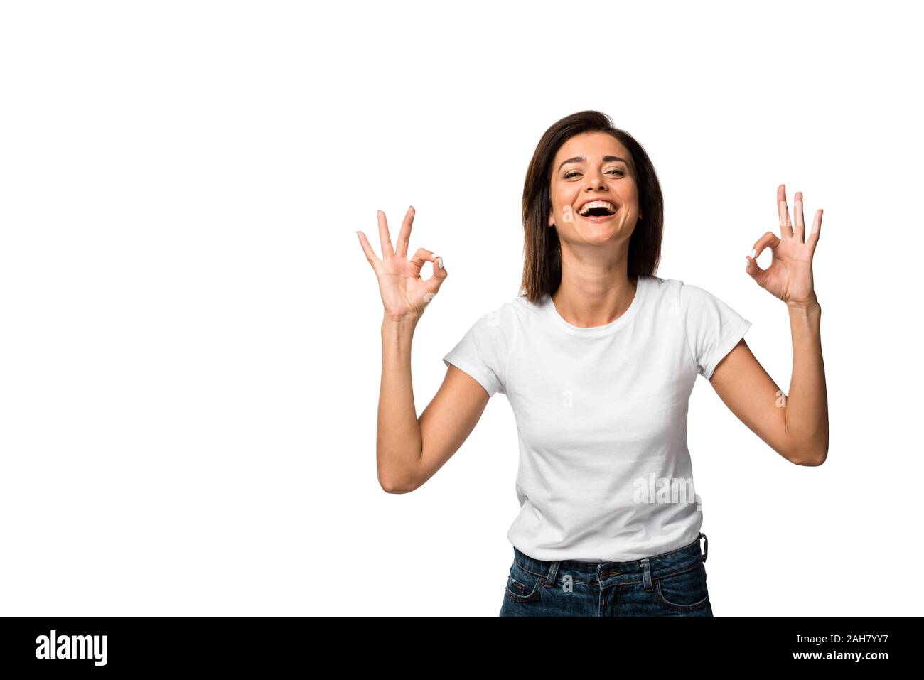 laughing woman in white t-shirt showing ok signs, isolated on white Stock Photo