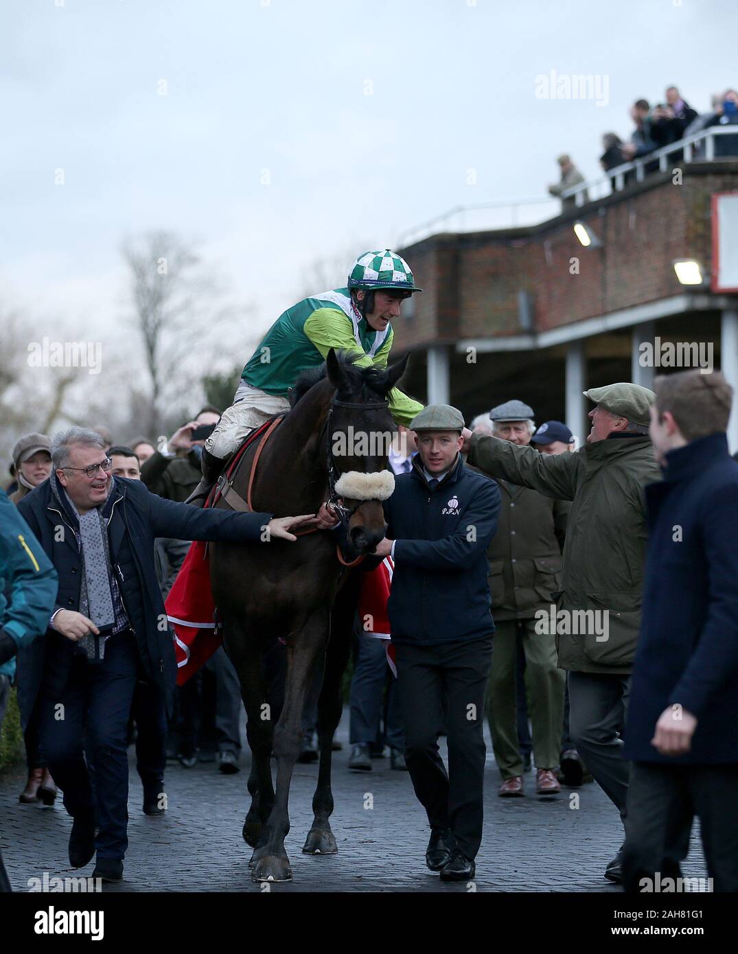 Clan Des Obeaux and jockey Sam Twiston-Davies with trainer Paul Nicholls after winning the Ladbrokes King George VI Chase during day one of the Winter Festival at Kempton Park Racecourse. Stock Photo