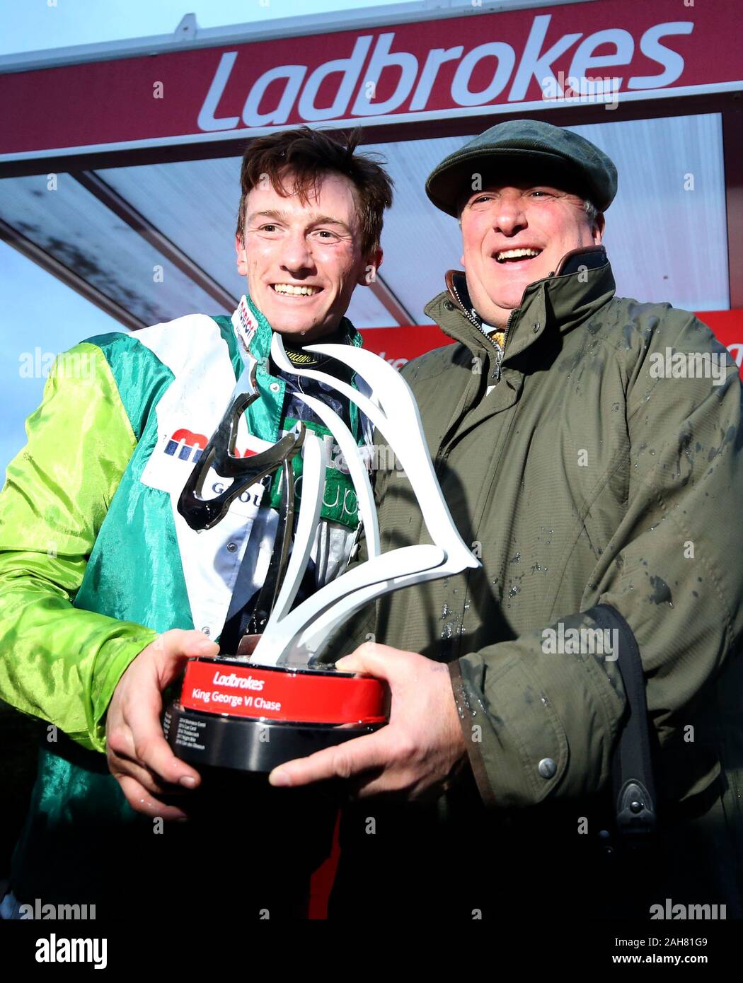 Jockey Sam Twiston-Davies with trainer Paul Nicholls after winning the Ladbrokes King George VI Chase onboard Clan Des Obeaux during day one of the Winter Festival at Kempton Park Racecourse. Stock Photo