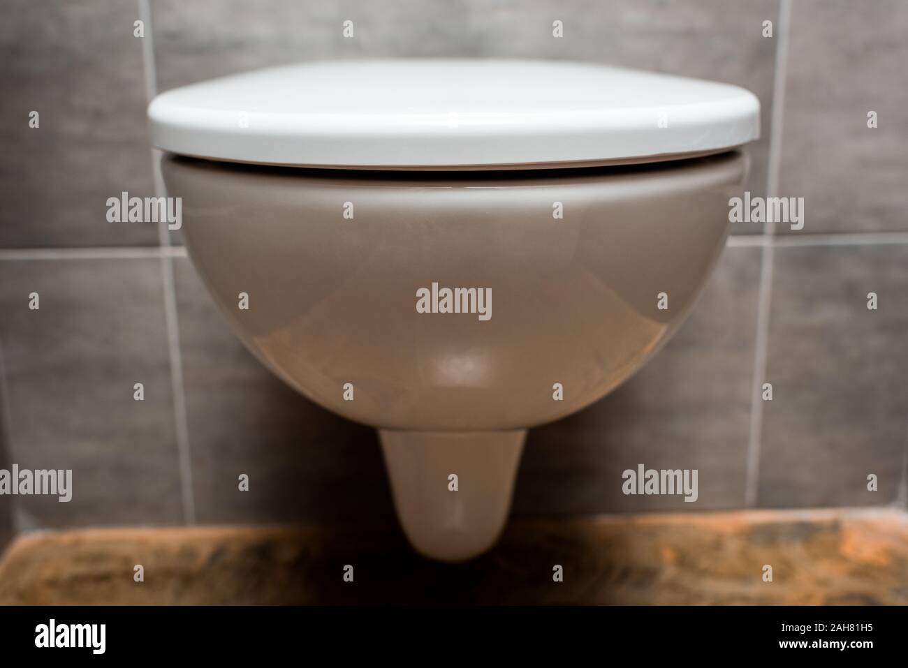 close up view of ceramic clean toilet bowl with lid in modern restroom ...